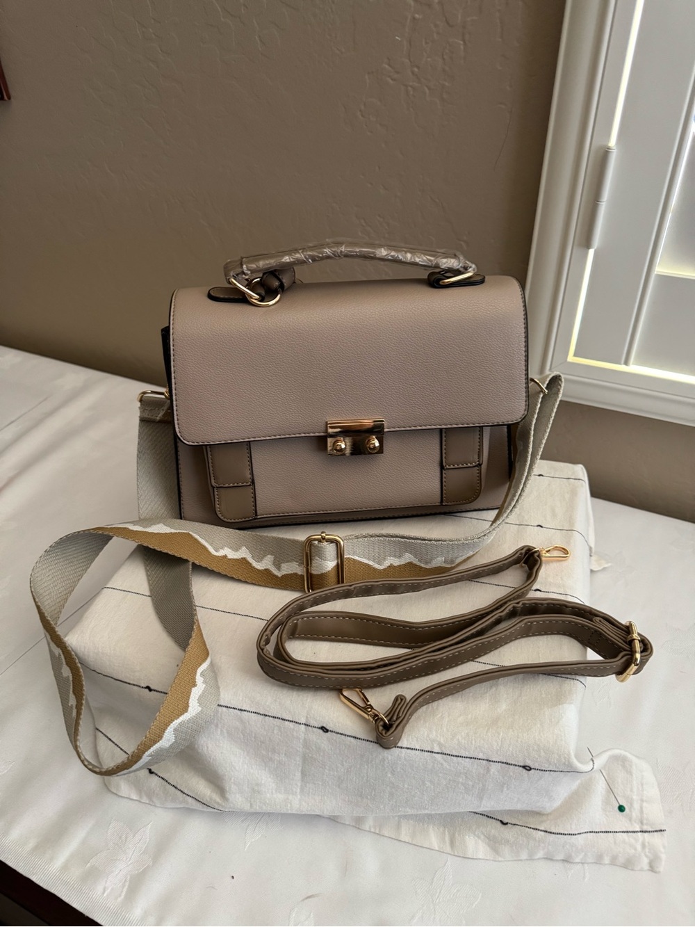 Crossbody satchel with gold hardware and a wide crossbody strap NWOT
